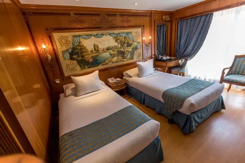 Panoramic lounge on Sonesta St. George Nile Cruise – refined interior filled with warm light and elegant ambiance